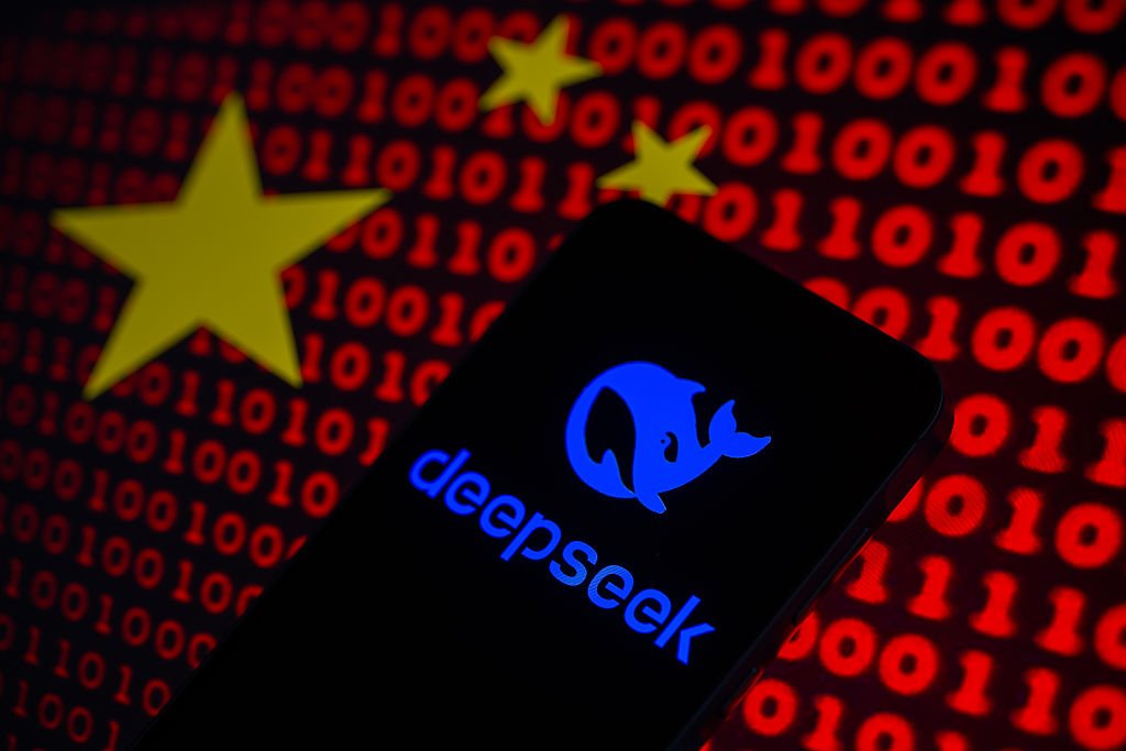 DeepSeek logo is displayed on a mobile phone screen with the flag of China and binary code in this photo illustration.
