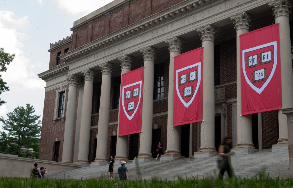 People walk past the Harry Elkins Widener Memorial Library on Harvard's campus on June 5, 2025.