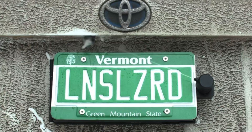 This backup camera cleaner hides behind your license plate